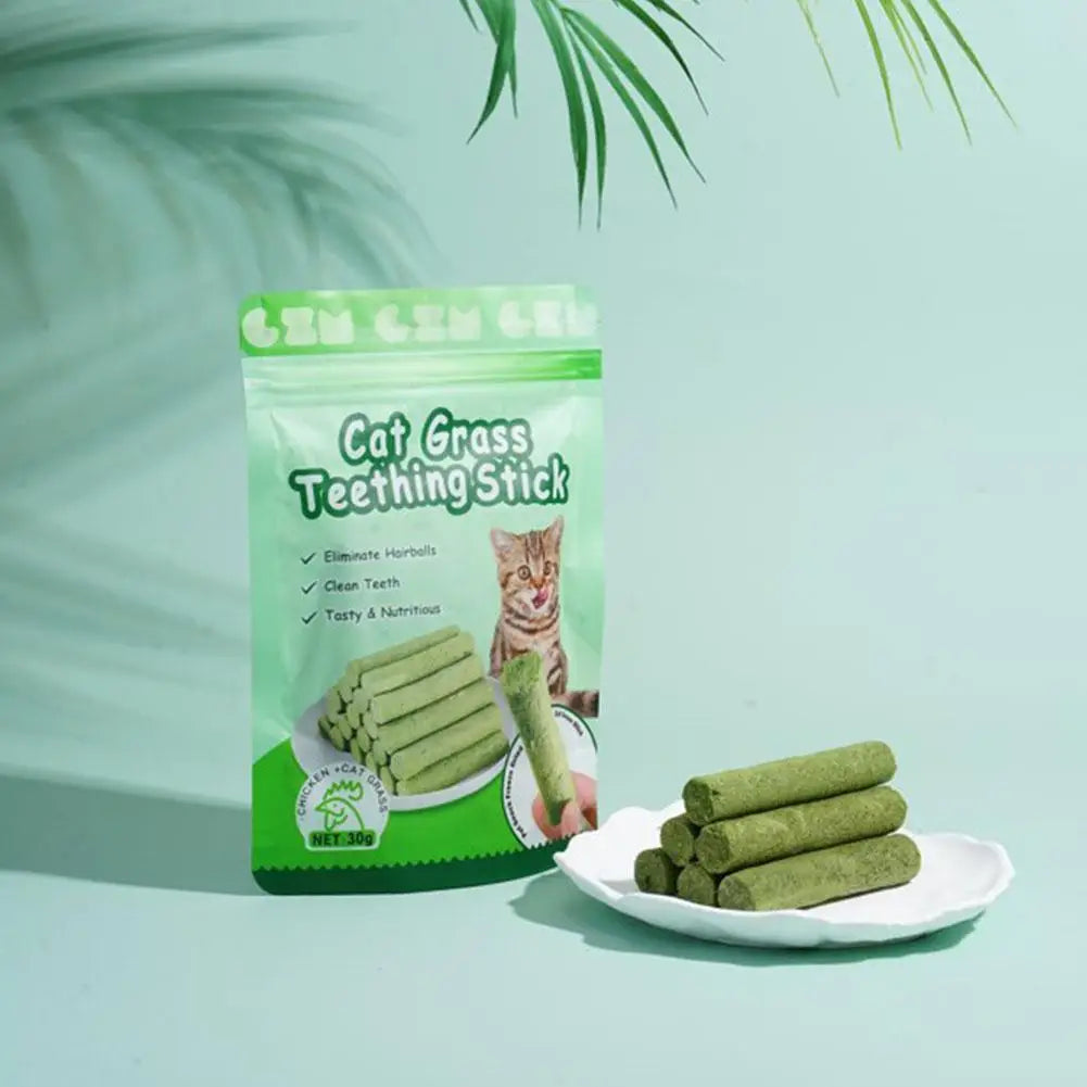 Cat grass teething sticks with packaging on a light green background