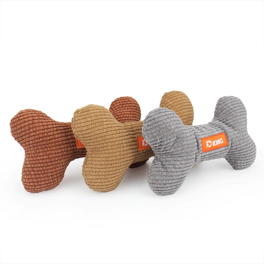Set of bone-shaped dog toys in brown and gray with an orange label on a white background