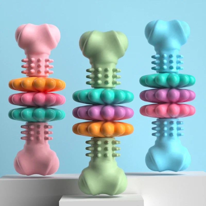 Three colorful dog toys shaped like bones on a light blue background