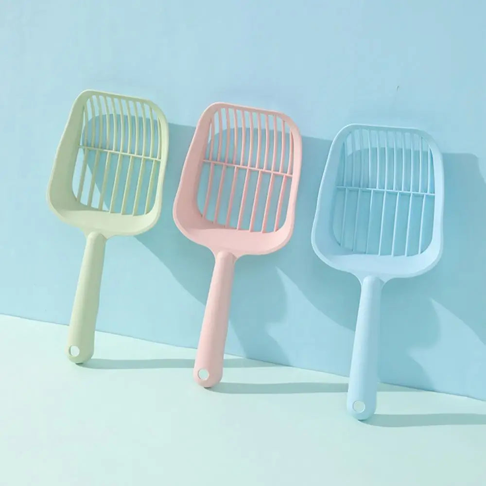 Three colorful pet grooming tools on a light blue background