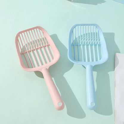 Two pet grooming tools, one pink and one blue, on a light blue background.
